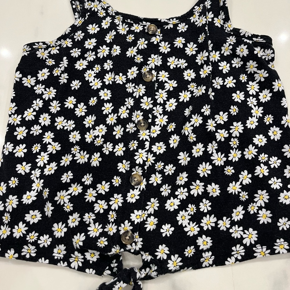 Black top with white floral pattern with decorative buttons and tie!
